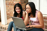 students reading on a laptop