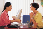 Two women working with computer