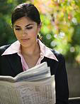 A woman reading newspaper